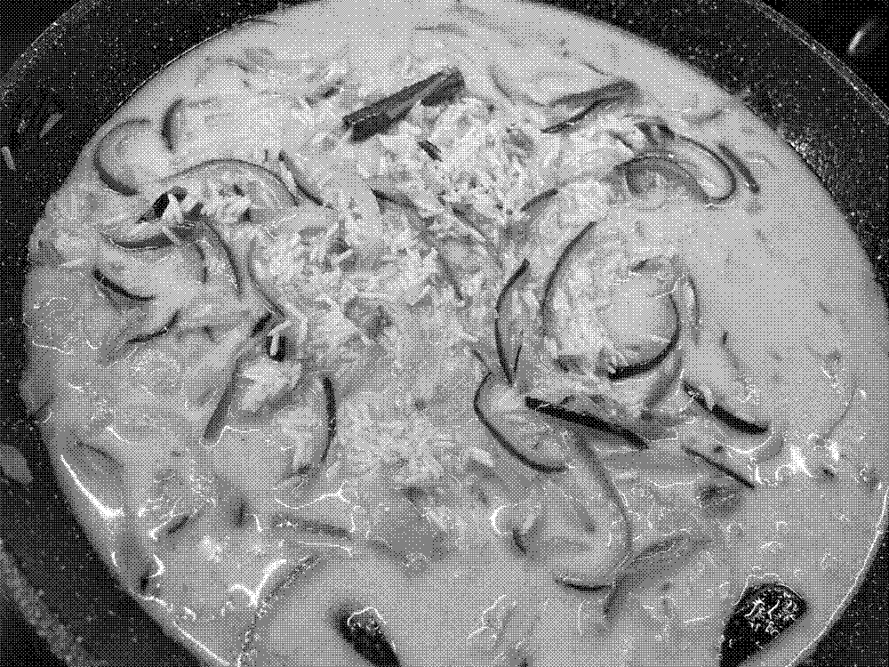 A pan of rice cooking in 'golden milk'.